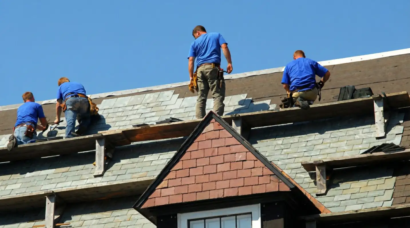 Roof replacement in progress with a team of professional contractors installing new shingles on a residential home in Duluth, MN