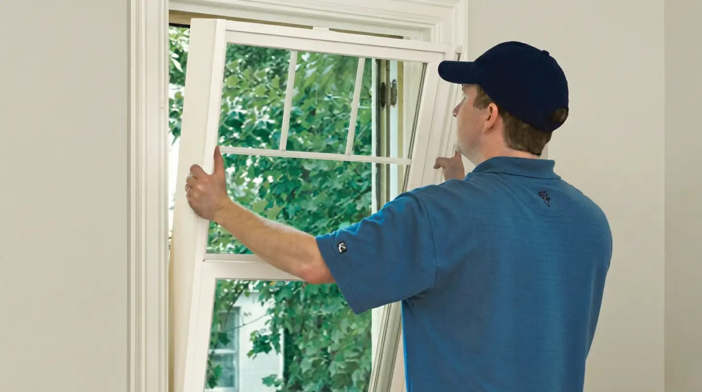 Professional contractors performing a residential window insulation and replacement service in Duluth, MN